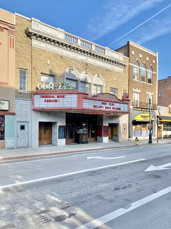 Built in 1926, this Renaissance Revival-style former movie theater was designed by Jack Raney.  The theater features a buff brick facade with second story windows featuring blind arches, a triple window over the front marquee with a limestone
