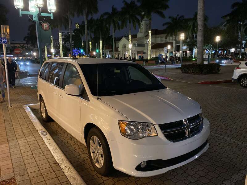 Dodge Grand Caravan (RT) STX trim photographed at night in Mizner Park, Boca Raton, Florida. Front view of this minivan finished in &quot;White Knuckle&quot; clear coat.