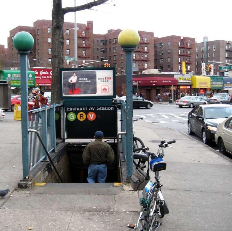 Looking east along 45th Avenue, at the southeastern (railroad north) staircase of en:Elmhurst Avenue (IND Queens Boulevard Line) on Broadway, on a cloudy late afternoon in early spring.