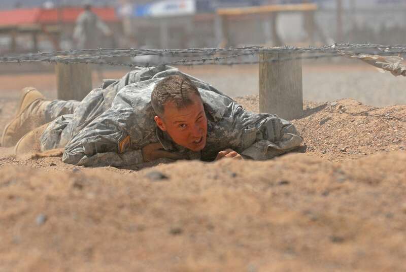 A soldier from the 1st Stryker Brigade Combat Team &quot;Ready First&quot;, 1st Armored Division, completes the low-crawl obstacle on the Fort Bliss obstacle course while competing for a chance to attend the U.S. Army Ranger School in the &quot;Ready First&quot; Ranger