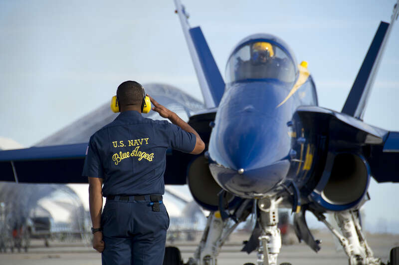 Petty Officer 3rd Class A.J. Varner, crew chief aviation ordnanceman, assigned to the U.S. Navy flight demonstration squadron, the Blue Angels, salutes the pilot prior to launching at Naval Air Facility El Centro. The Blue Angels are in El Centro to
