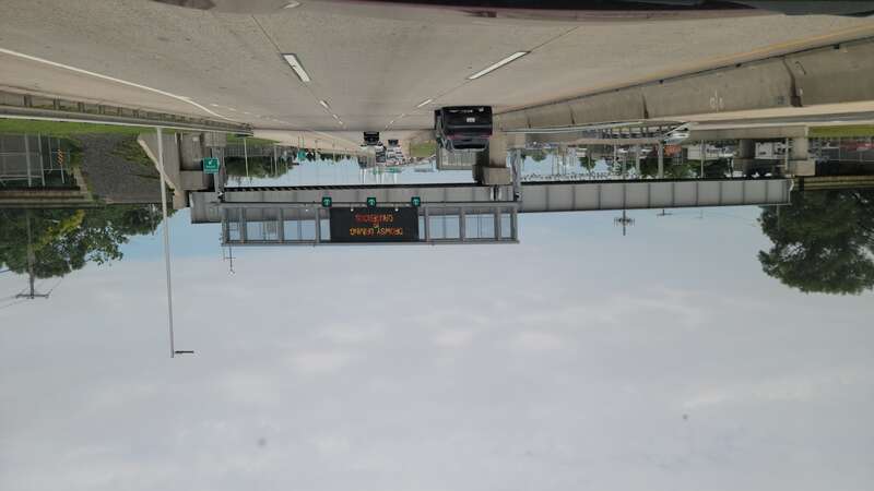 Traveling west through the former toll plaza towards the new Goethals Bridge, at Goethals Road North / Gulf Avenue and Western Avenue in Old Place / Arlington / Bloomfield, Staten Island. In the foreground is a 1960s-esque Port Authority sign gantry,