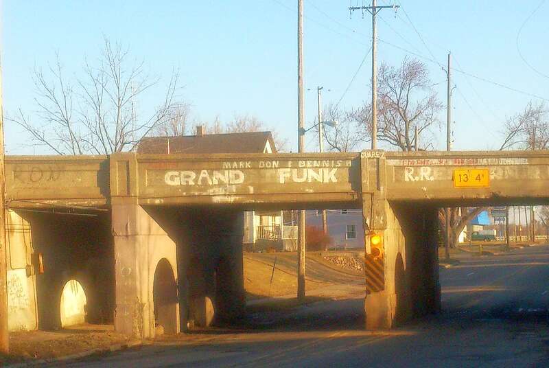 Grand Funk Railroad Bridge, Flint, Michigan: A Grand Trunk Western Railroad bridge that was re-painted to instead show the name of American rock band Grand Funk Railroad. Located in their home town, over Fenton Road, Flint, Michigan, 48507