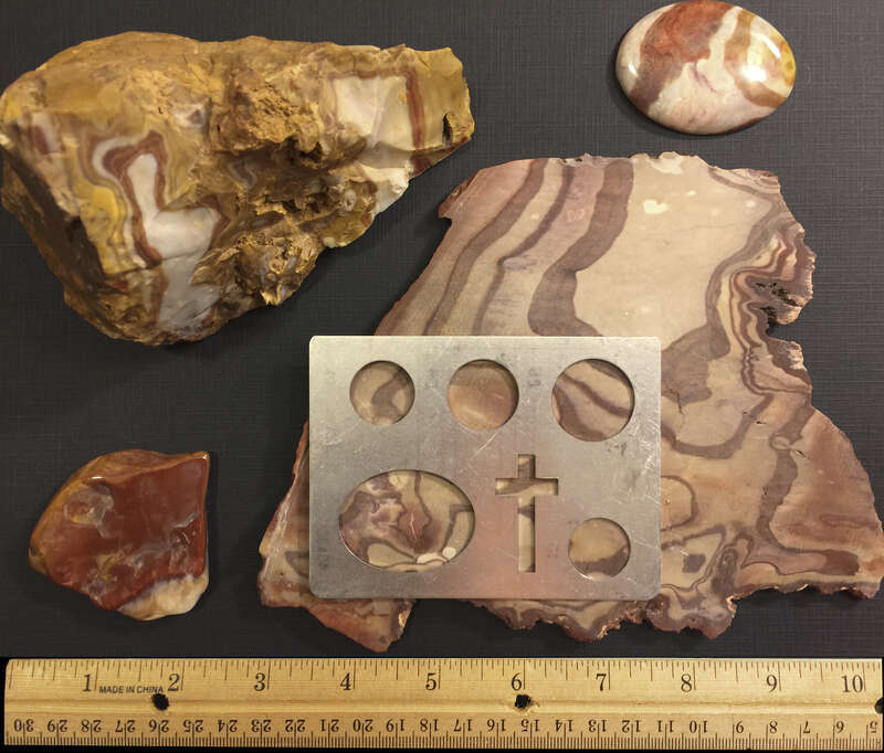 In the upper left we see a hunk of a rock. This rock is chalcedony or quartz. Such unfinished rock is called rough. In the upper right we see a finished piece called a cabochon. Cabochons, big or small, are often put into jewelry.
The rough is cut