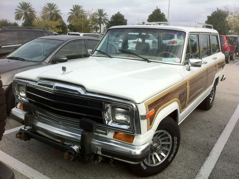 Jeep Grand Cherokee (SJ) finished in white - front view of pioneering luxury SUV. Note: equipped with a bracket for towing by RV. Photographed in Orlando, Florida.