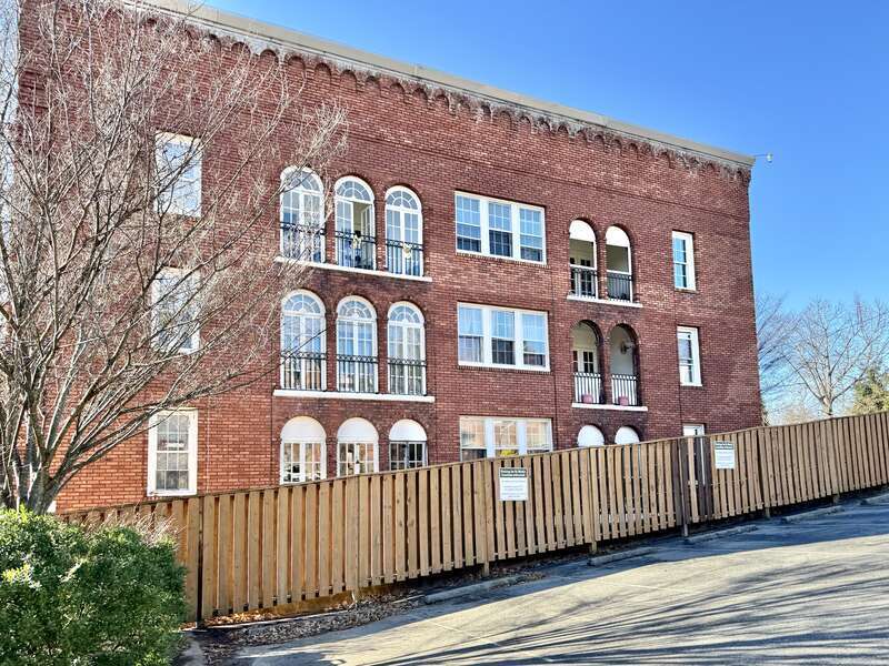 Built in 1923, this Romanesque Revival-style building was designed by Ronald Greene to serve as the Jefferson Apartments.  The building features a red brick exterior with four-over-four, six-over-six, and eight-over-eight double-hung windows, arched