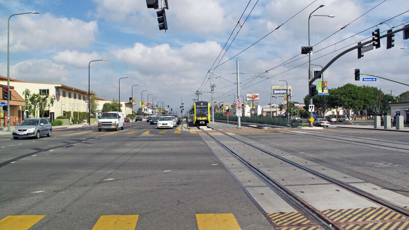 Southbound K Line train (LA Metro) approaching Hyde Park station. View is of Crenshaw Blvd. north of Slauson Avenue.