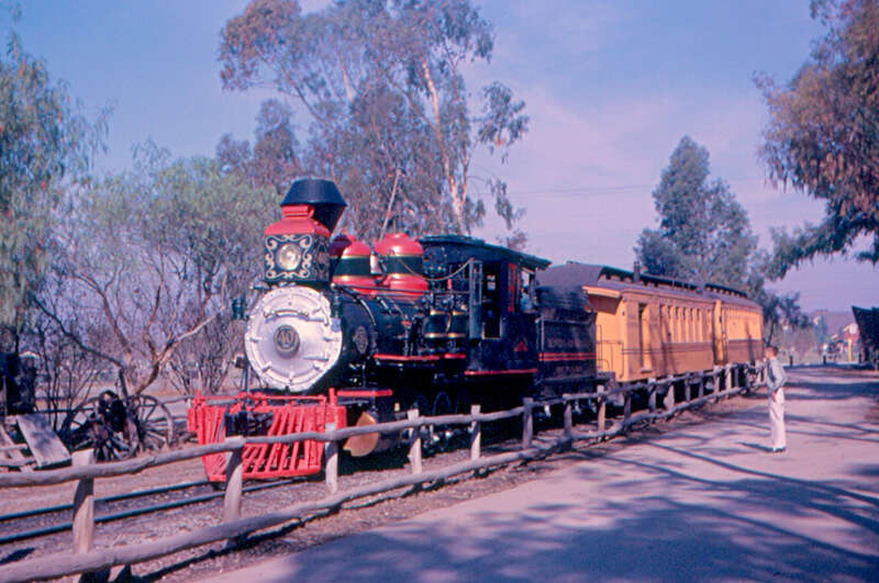 An old steam train at Knott's Berry Farm, in Buena Park, near Los Angeles.   Knott's Berry Farm developed out of a roadside stand and restaurant.  The ghost town was built in 1940, from buildings bought in from outside, and the railroad came later.