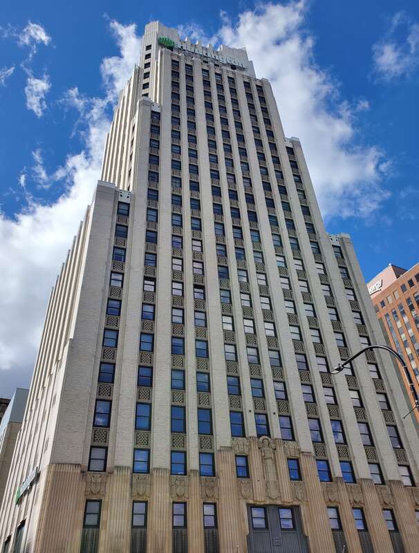 Looking up the face of the Huntington Tower in Akron on a mildly cloudy day.