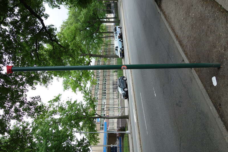 An &quot;empty&quot; bus stop sign pole at the Q20/Q44 bus stop on the west side of Main Street south of 63rd Avenue / Reeves Avenue in Queensboro Hill / Kew Gardens Hills, Flushing, Queens. John Bowne High School is across the street to the east.