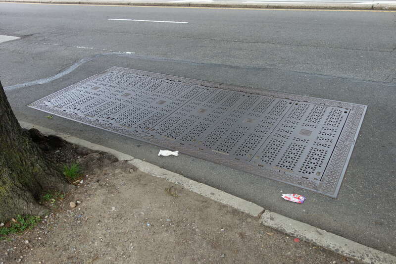A ConEdison utility cover on the west side of Main Street south of 63rd Avenue / Reeves Avenue in Queensboro Hill / Kew Gardens Hills, Flushing, Queens.