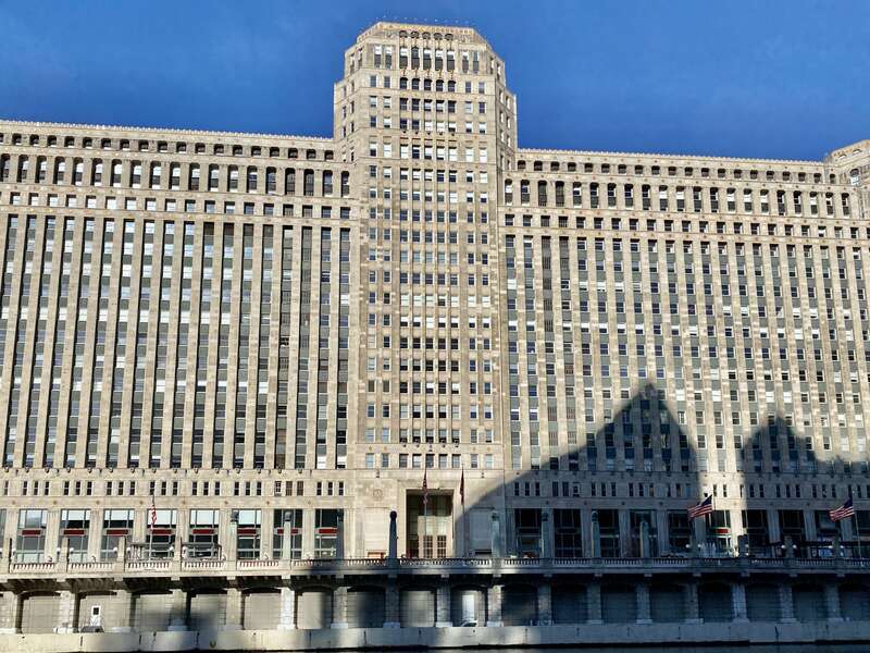 Built in 1928-1930, this Art Deco-style building was designed by Graham, Anderson, Probst and White for Marshall Field and Company, and is known as Merchandise Mart, housing multiple retail and wholesale operations on the former site of a train yard,