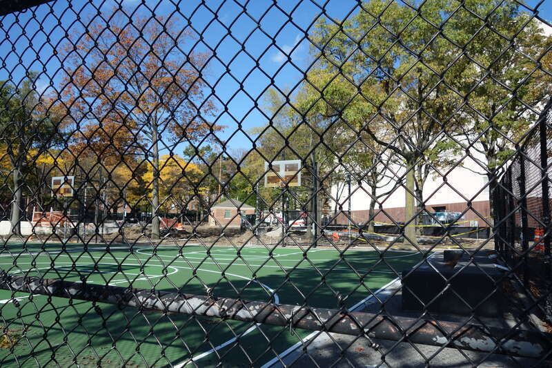 Looking into the basketball courts at the south end of Clement Clarke Moore Homestead Playground, on 45th Avenue between Broadway and 82nd Street in Elmhurst, Queens. The entire park is undergoing a major reconstruction project. Note that although