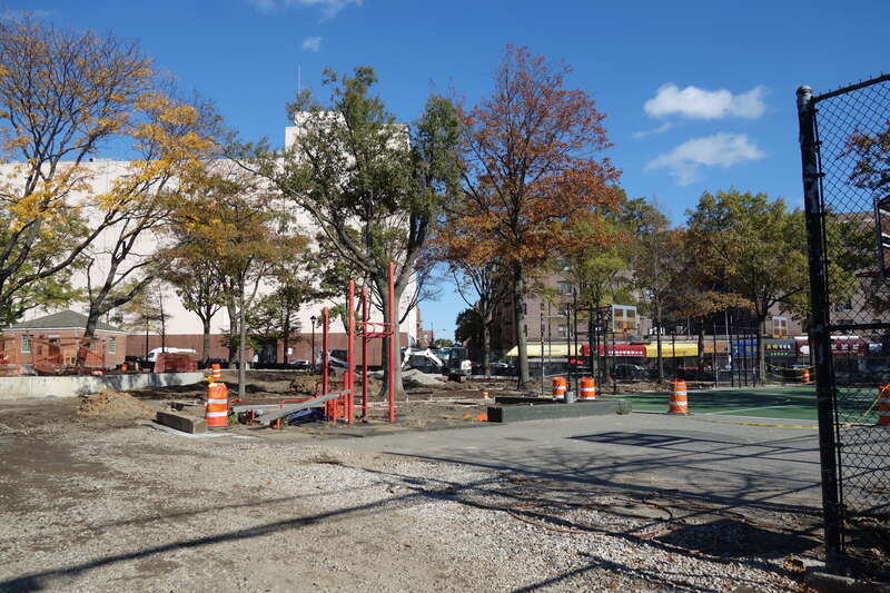 The entrance to the playing courts at the south end of Clement Clarke Moore Homestead Playground, on 45th Avenue between Broadway and 82nd Street in Elmhurst, Queens. The entire park is undergoing a major reconstruction project. Pictured is an adult