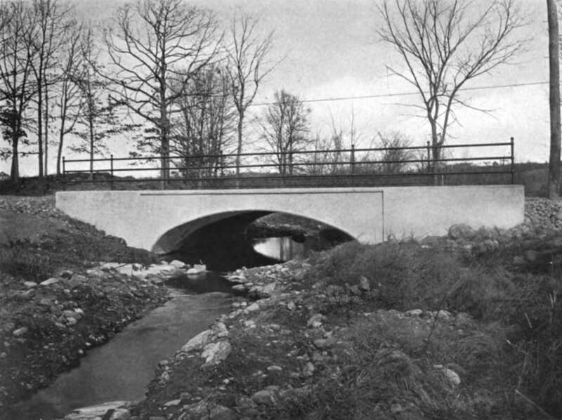 The newly-constructed arch bridge carrying Mower Street over Tatnuck Brook in the Tatnuck section of Worcester, Massachusetts, seen in late 1912. It also carried the West Tanuck line of the Worcester Consolidated Street Railway, which paid $1,200 of