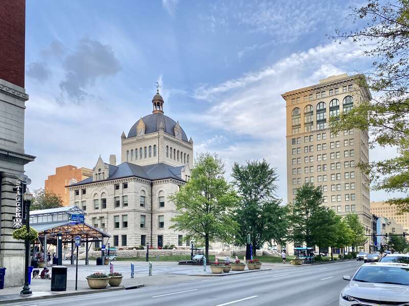 On the left, built in 1898-1900, this Richardsonian Romanesque Revival-style building was designed by Lehman and Schmitt to serve as the Fayette County Courthouse, and is the fifth courthouse to serve Fayette County, replacing a previous courthouse,