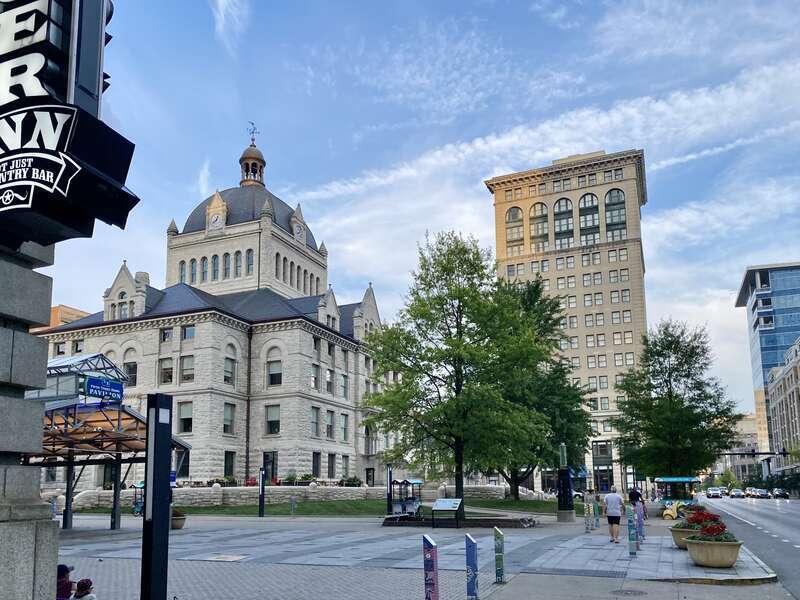 On the left, built in 1898-1900, this Richardsonian Romanesque Revival-style building was designed by Lehman and Schmitt to serve as the Fayette County Courthouse, and is the fifth courthouse to serve Fayette County, replacing a previous courthouse,