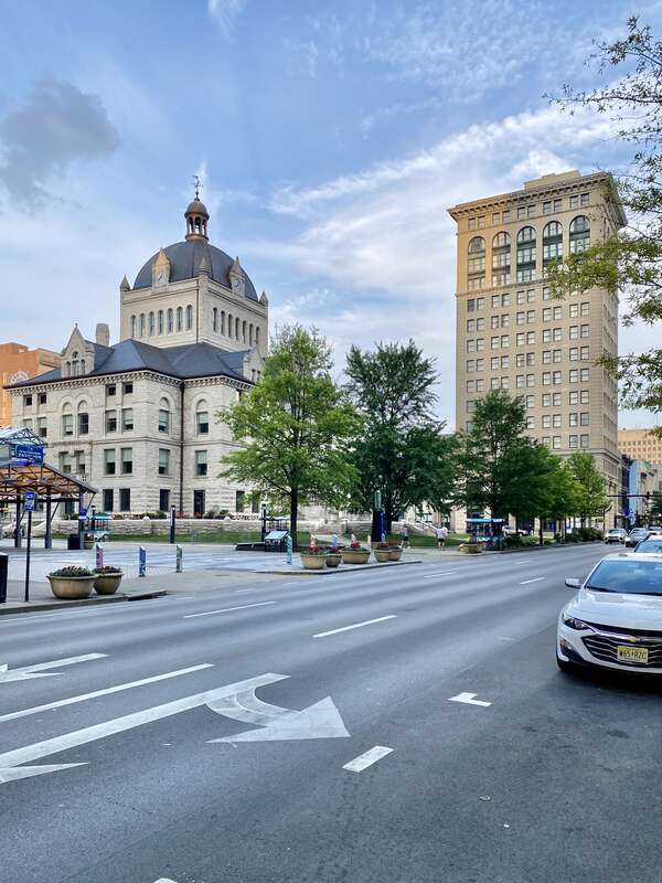 On the left, built in 1898-1900, this Richardsonian Romanesque Revival-style building was designed by Lehman and Schmitt to serve as the Fayette County Courthouse, and is the fifth courthouse to serve Fayette County, replacing a previous courthouse,