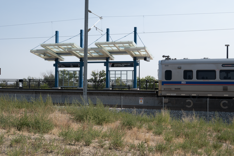 Original Thornton &amp;amp; 88th RTD station viewed from west. In foreground a southbound RTD commuter rail train is departing the station.