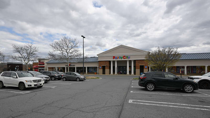 The Party City store in the Kentlands Market Square shopping center with a parking lot full of cars.  Kentlands neighborhood, Gaithersburg, Maryland.