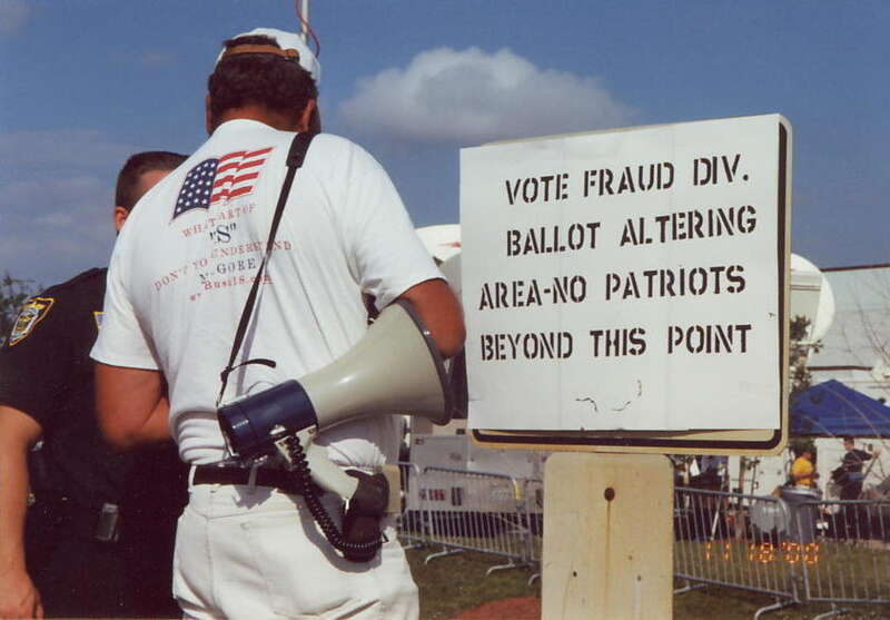 Protestor at Palm Beach County recount during 2000 election aftermath.  The cop made him take down his sign.