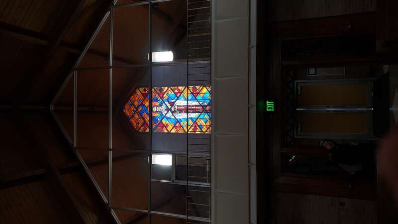 Rear stained glass window of St. Teresa