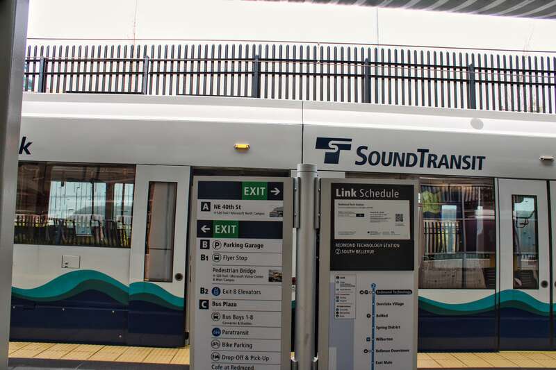 Platform and exit information at Redmond Technology 2 Line station, shot in April 2024. A train to Bellevue is also shown parked across the platform.
