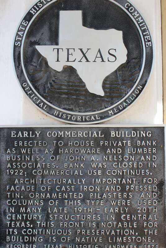 Early Commercial Building. Erected to house private bank as well as hardware and lumber business of John A. Nelson and Associates. Bank was closed in 1922; commercial use continues. Architecturally important for facade of case iron and pressed tin.