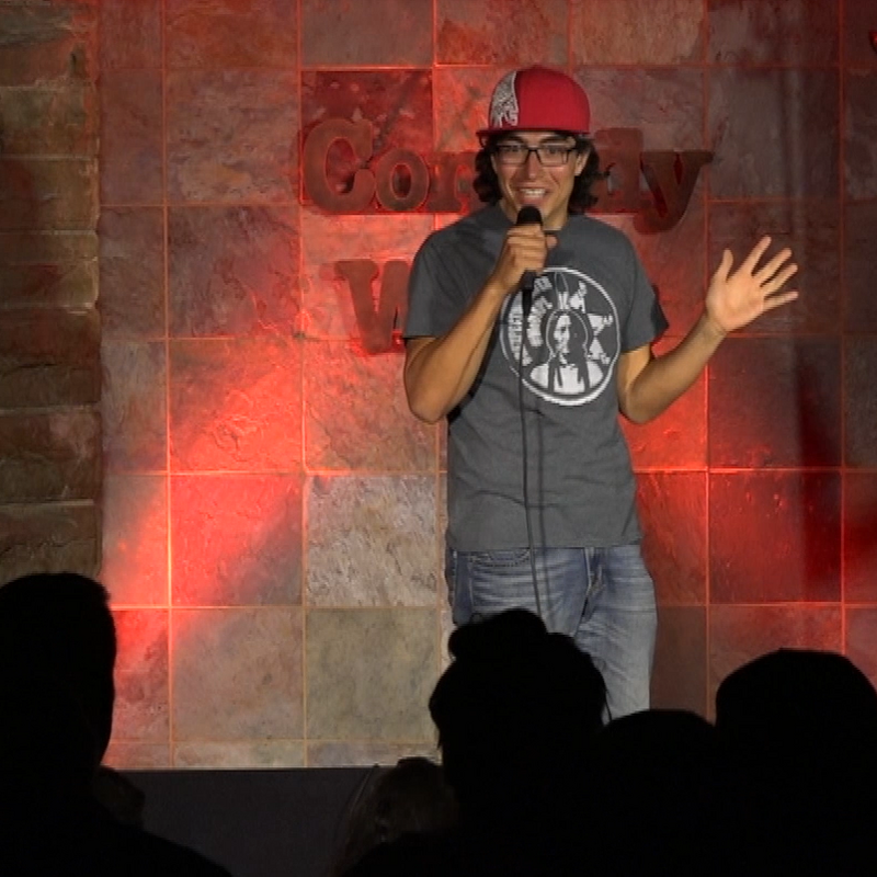 Sam Malcolm delivers a joke to a crowd during a comedy set at Comedy Works in Denver, Colorado, USA in 2017.
