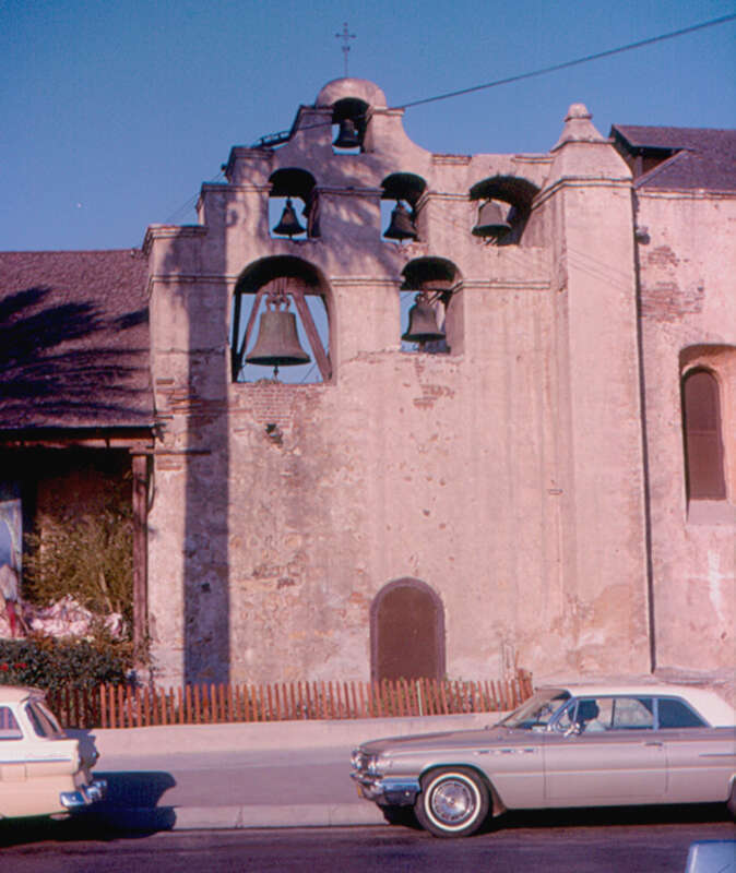 Mission San Gabriel Arcangel was founded by Fra Junipero Serra in 1771.  This is the bell wall (&quot;campanato&quot;).  A Buick is in the foreground, but I do not know the year.