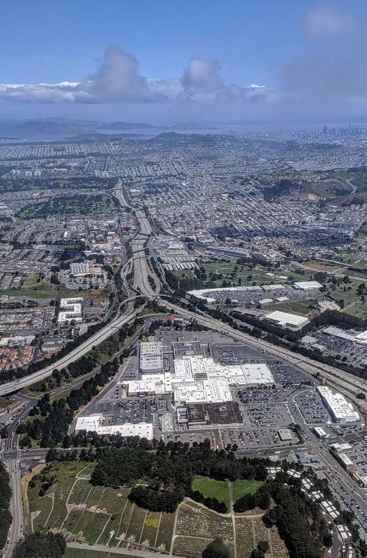 Aerial view from the south of Serramonte Center, Daly City, California, between California 1 and I-280, with San Francisco in the background