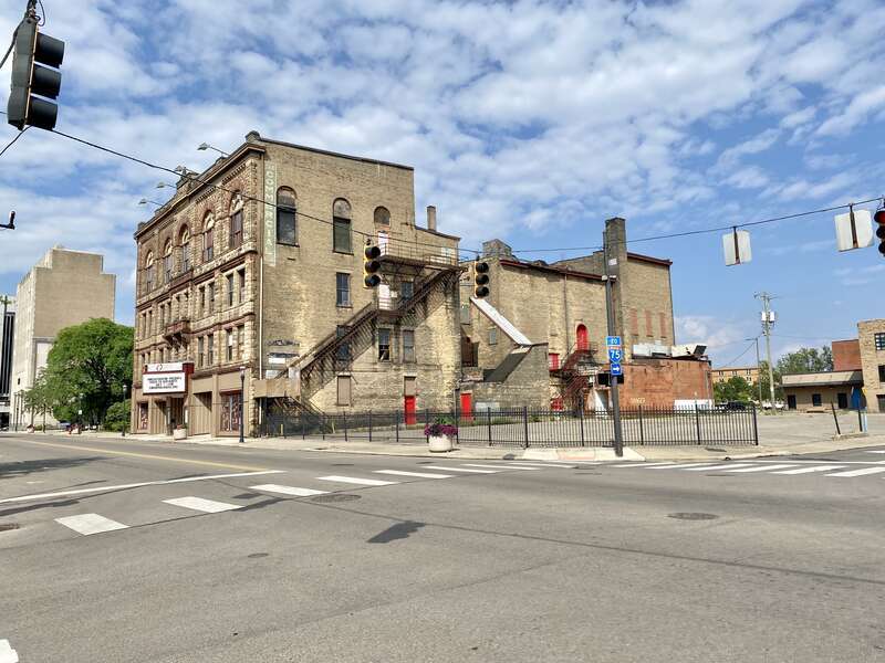 Built in 1890, this Richardsonian Romanesque Revival-style building was designed by Samuel Hannaford for Paul J. Sorg to serve as an opera house.  The building features a brick exterior with a rough-hewn stone front facade, arched window bays on the
