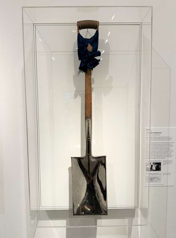 A spade in a museum display that was used by May Wright Sewall to ceremonially break ground for a John Herron Art Institute building on September 23, 1905 at 4pm. The museum description states it was created by an unknown manufacturer from wood and