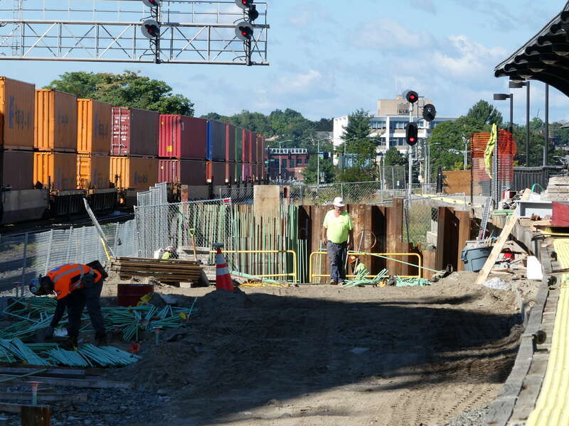 Construction work on the tunnel to the new second platform at Worcester Union Station in September 2022. At left, a CSX freight train passes.