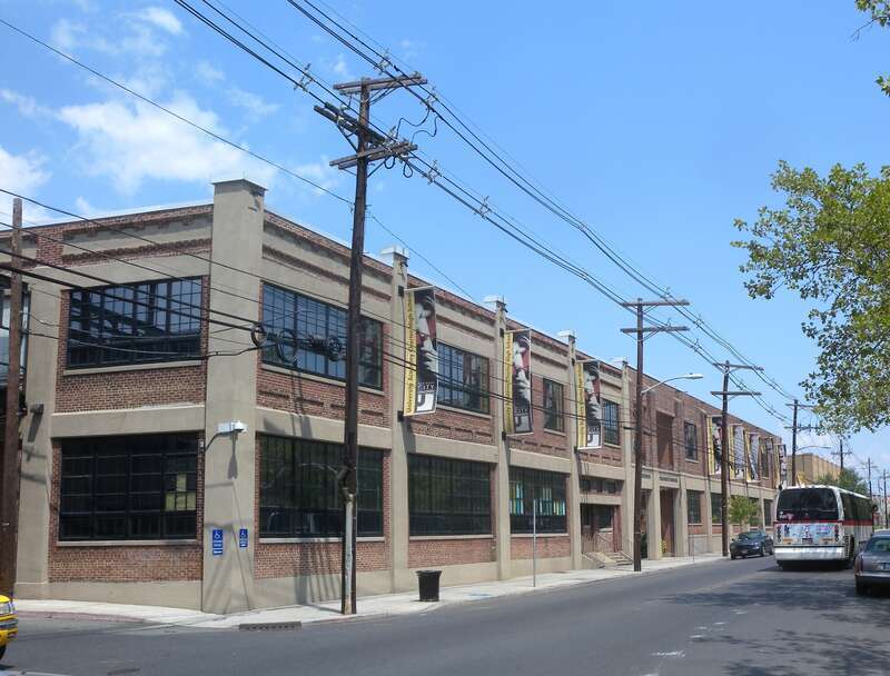 Looking north along West End Avenue at University Academy Charter High School on a mostly sunny midday.