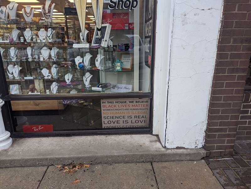 A &quot;We Believe&quot; sign (with a white background instead of the usual black) in a store window. Picture take in Lawrence, Kansas. Picture taken in March 2023.