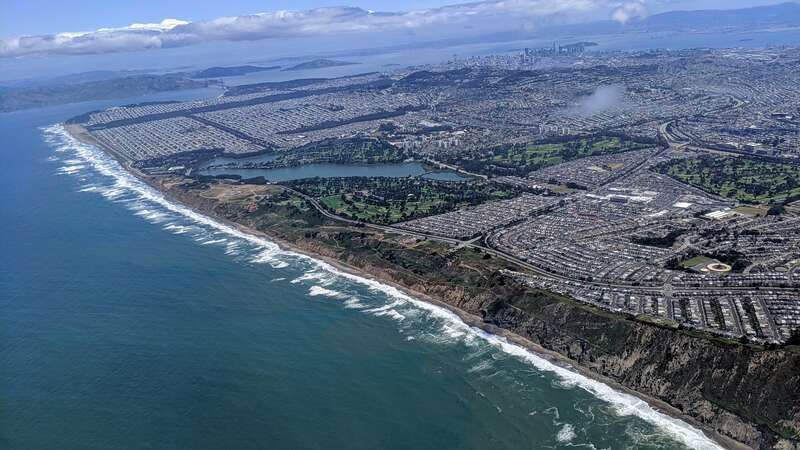 Aerial view from the southwest of Westlake (right foreground), a neighborhood of Daly City, California, with San Francisco's Lake Merced and more behind