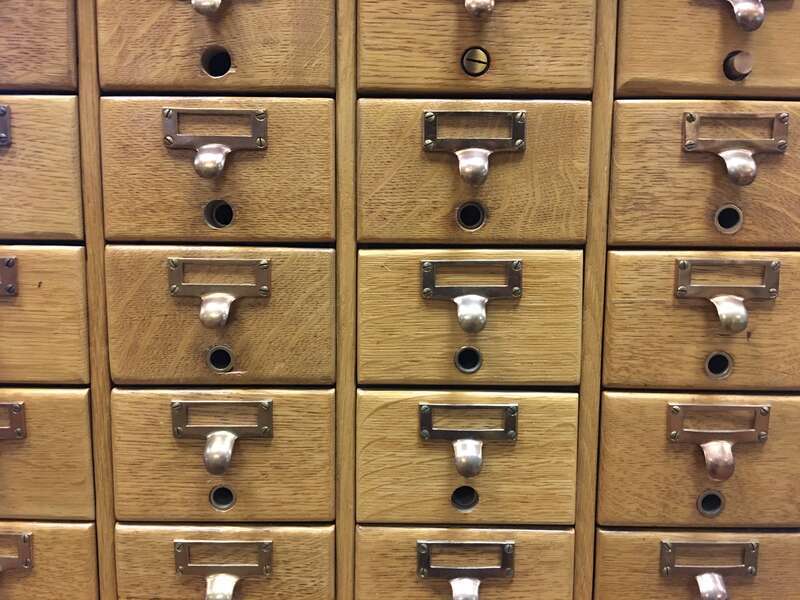 A wooden card catalog chest of drawers at a public library in Nashua, New Hampshire