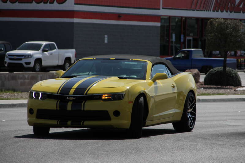 A yellow 2014-15 Chevrolet Camaro RS convertible with black stripes is making a turn on N Jones Boulevard, Las Vegas, Nevada. It is unknown wether it was making a U-turn or trying to turn into a Lowe's parking lot.