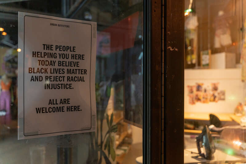 A sign welcoming everyone posted on the front door of Urban Outfitters in Uptown Minneapolis.