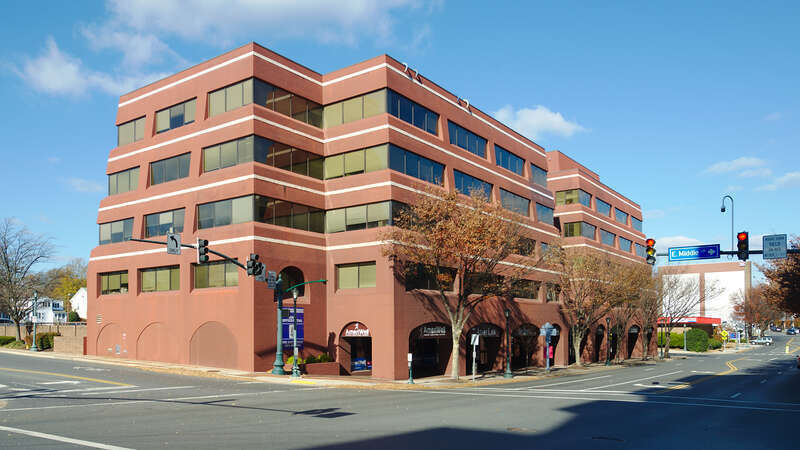 A slanted five story building on the corner of N. Washington St and W. Middle Ln. 110 North Washington Street, Rockville, Maryland 20850.