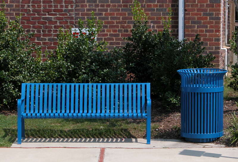 Metal blue street bench and matching garbage receptacle in Carrboro, North Carolina.