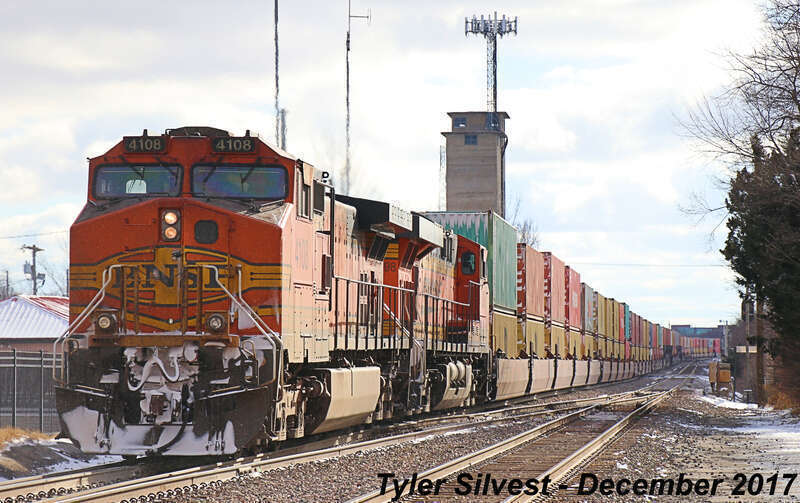 Burlington Northern Santa Fe 3857(ET44C4), 5489(C44-9W), 6820(ES44C4), 4295(ES44C4), 6988(ES44C4), 8353(ES44C4), 8130(ES44C4), 6514(ES44C4), 5898(ES44AC) and 4108(C44-9W) Lead a Westbound 15,176 foot long Intermodal on the BNSF Emporia Sub near Loula