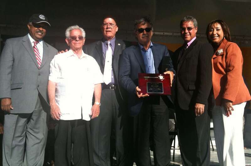 Radio broadcaster and Spanish Broadcasting System co-founder Raúl Alarcón, Jr. (holding plaque) in Union City, New Jersey, where he accepted honors for his father, Pablo Raúl Alarcón, Jr., on June 2, 2011 with a star at the Celia Cruz Plaza Walk of