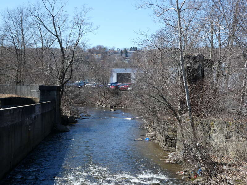 Abutments of the former Meriden, Waterbury and Connecticut River Railroad bridge over the Mad River in Waterbury, seen in March 2023