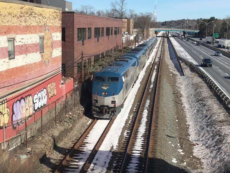 The Boston section of the Amtrak Lake Shore Limited passes Auburndale station headed westbound in February 2021. This train is bound first for Albany, where it will merge with the New York City section coming up the Hudson Valley from Penn Station.