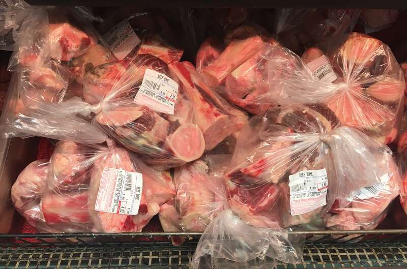 Beef bones for making stock or broth packaged for sale at a supermarket in the Asian District of Oklahoma City, Oklahoma, USA.