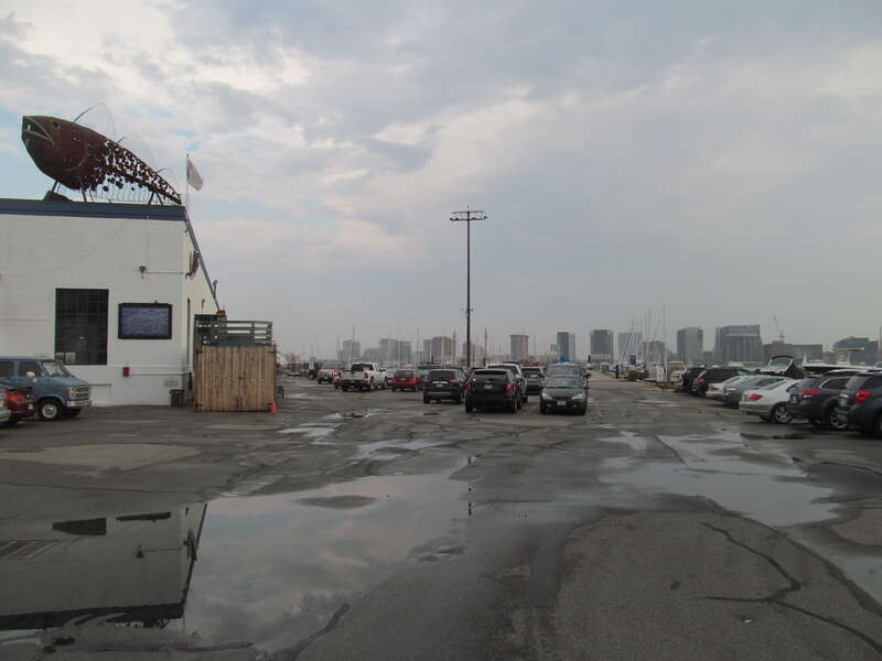The Boston Harborwalk winds through this parking lot and onto the pier at right to the Nantucket at Boston Harbor Shipyard &amp;amp; Marina. Until 1940, the Boston, Revere Beach and Lynn Railroad ran through the photographer's location and to East Boston