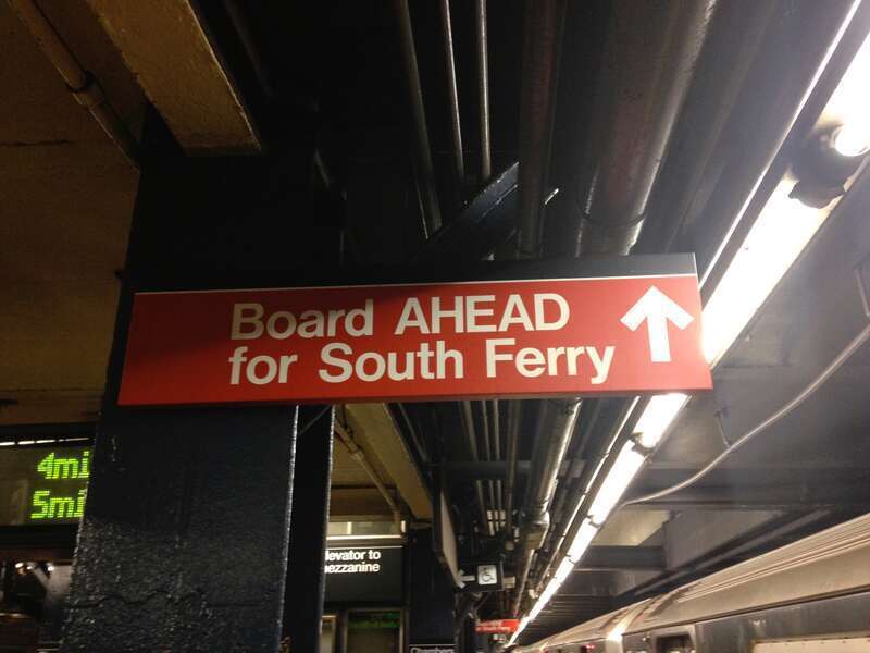 A sign at the Chambers Street IRT station, advising passengers to enter Downtown trains on the far end of the platform to access the then-short length South Ferry station. This sign has since been removed.