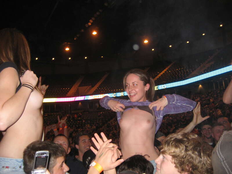 Female fans flashing their breasts at a Godsmack concert in Moline, Illinois on November 5, 2006